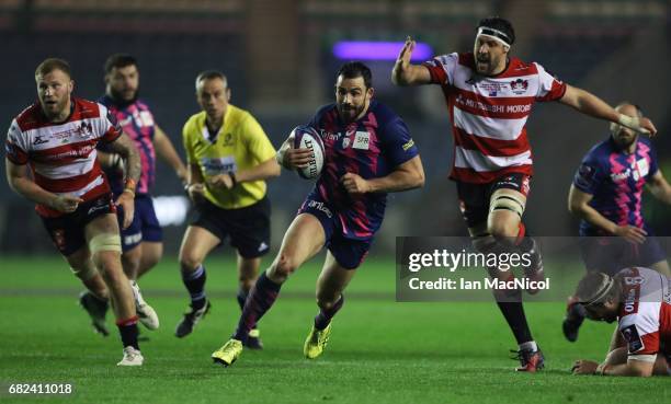 Geoffrey Doumayrou of Stade Francais breaks through the Gloucester defence to score his team's third try during the European Rugby Challenge Cup...