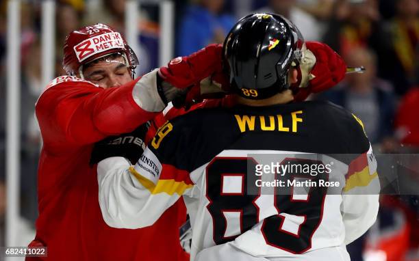 Oliver Lauridsen of Denmark fights with David Wolf of Germany during the 2017 IIHF Ice Hockey World Championship game between Denmark and Germany at...