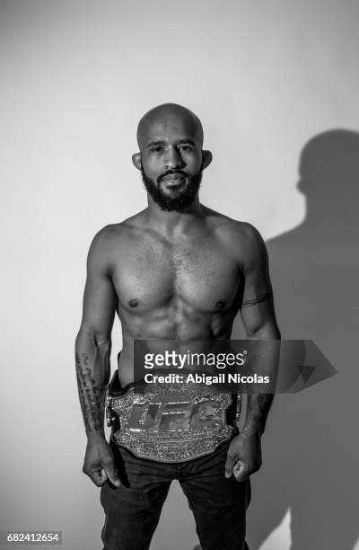 Portrait of UFC Flyweight champion Demetrious Johnson posing with belt during photo shoot at Time Inc. Studios. Johnson has succesfully defended his...