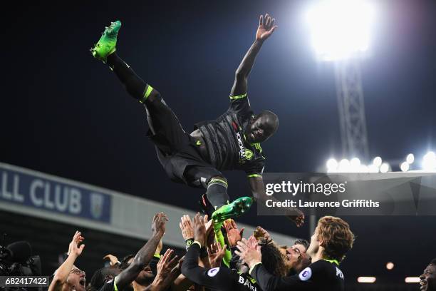 Golo Kante of Chelsea is chucked in the air by team mates while celebrating winning the leauge title after the Premier League match between West...