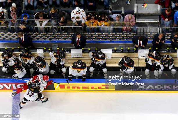 Julian Jakobsen of Denmark challenges Marcus Kink of Germany for the puck during the 2017 IIHF Ice Hockey World Championship game between Denmark and...
