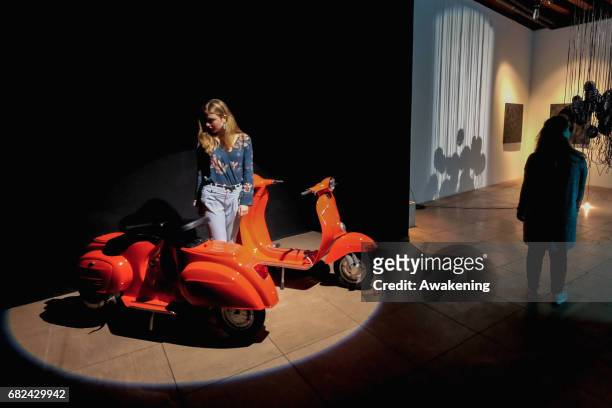 Visitors attend the collaterals exhibition 'Modus' of WAVEs during the 57th Biennale Arte on May 12, 2017 in Venice, Italy. The 57th International...