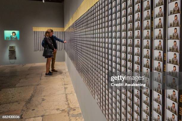 Visitors attend the collaterals exhibition 'Doing Time' during the 57th Biennale Arte on May 12, 2017 in Venice, Italy. The 57th International Art...