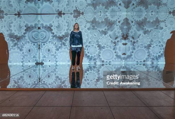 Visitors attend the collaterals exhibition 'Modus' of WAVEs during the 57th Biennale Arte on May 12, 2017 in Venice, Italy. The 57th International...