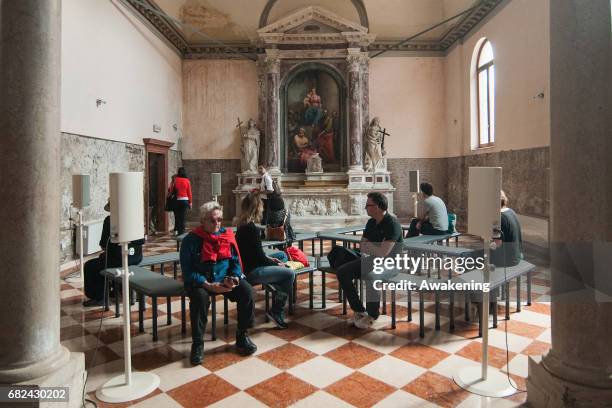 Visitors attend the collateral exhibition 'Wales in Venice: James Richards' of Cymru yn Fenis Wales in Venice during the 57th Biennale Arte on May...