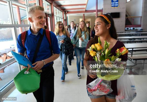 Clear Creek High School seniors, Gavin Arneson, left, a National Honors Society scholarship recipient and Abigail Mellon make their way to the school...