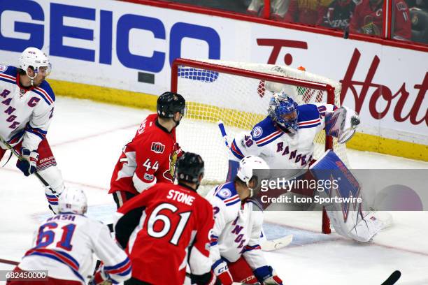 New York Rangers Goalie Henrik Lundqvist gets a piece of the puck as the rebound heads over the net during the first period of Game 5 of the 2nd...