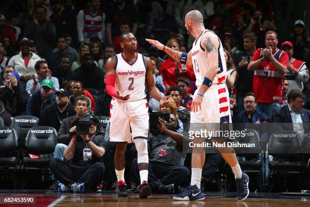 John Wall and Marcin Gortat of the Washington Wizards high five each other during the game against the Boston Celtics during Game Six of the Eastern...