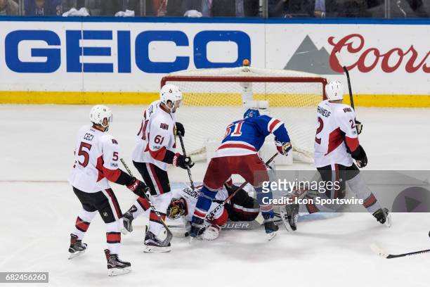 New York Rangers left wing Rick Nash looks for a loose puck, as Ottawa Senators goalie Craig Anderson covers it up, during the second period of game...