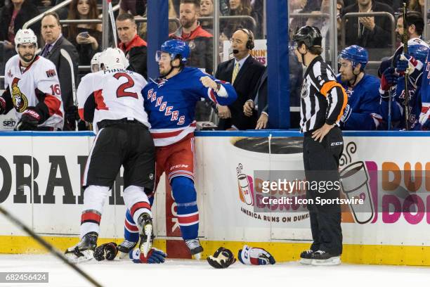 New York Rangers defenseman Brendan Smith and Ottawa Senators defenseman Dion Phaneuf tangle up during the third period of game 4 of the second round...