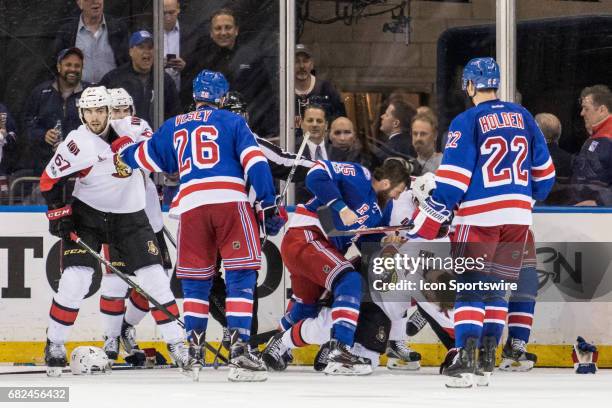 New York Rangers left wing Tanner Glass slams Ottawa Senators center Kyle Turris to the ice during the third period of game 4 of the second round of...