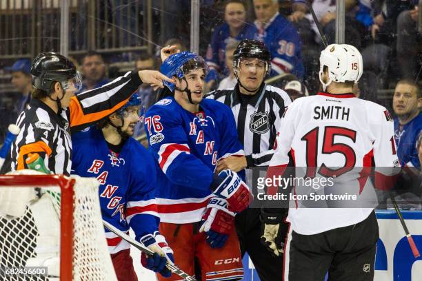Referees separate New York Rangers defenseman Brady Skjei and Ottawa Senators center Zack Smith during the first period of game 4 of the second round...