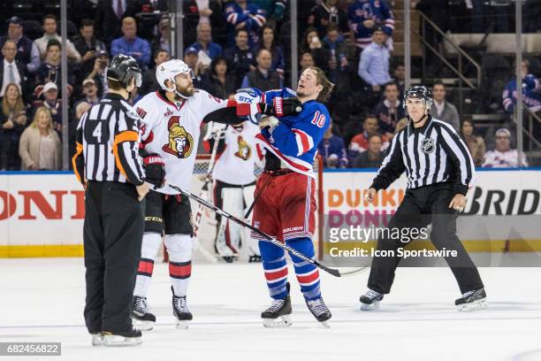 Referees move in, as Ottawa Senators left wing Viktor Stalberg and New York Rangers center J.T. Miller exchange blows center ice during the third...