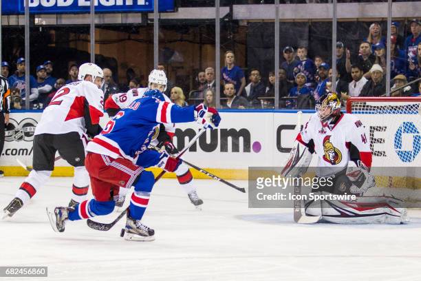 New York Rangers right wing Mats Zuccarello mis-handles the puck in front of Ottawa Senators goalie Craig Anderson during the first period of game 6...