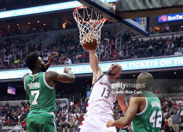 Marcin Gortat of the Washington Wizards dunks against Jaylen Brown and Al Horford of the Boston Celtics during Game Six of the NBA Eastern Conference...