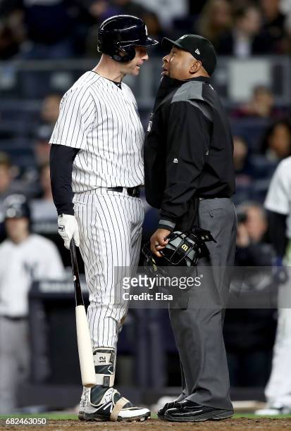 Chase Headley of the New York Yankees argues home plate umpire Adrian Johnson after Headley disagreed with a call in the seventh inning against the...