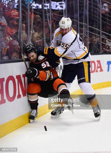 Cody McLeod of the Nashville Predators checks Shea Theodore of the Anaheim Ducks into the end boards during the second period of Game One of the...