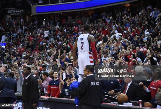 John Wall of the Washington Wizards celebrates after hitting the game-winning three against the Boston Celtics after Game Six of the Eastern...