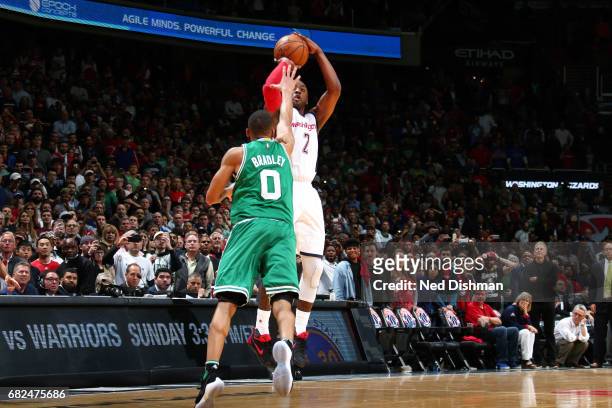 John Wall of the Washington Wizards hits the game winning three-point shot during the game against the Boston Celtics during Game Six of the Eastern...