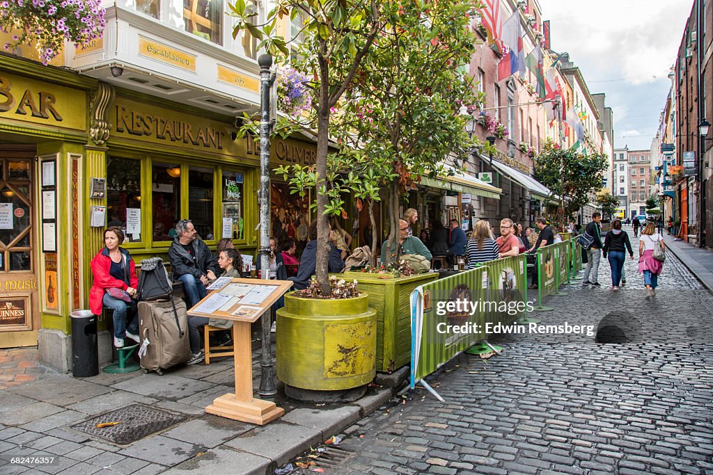 People dining outside of a traditional Irish bar