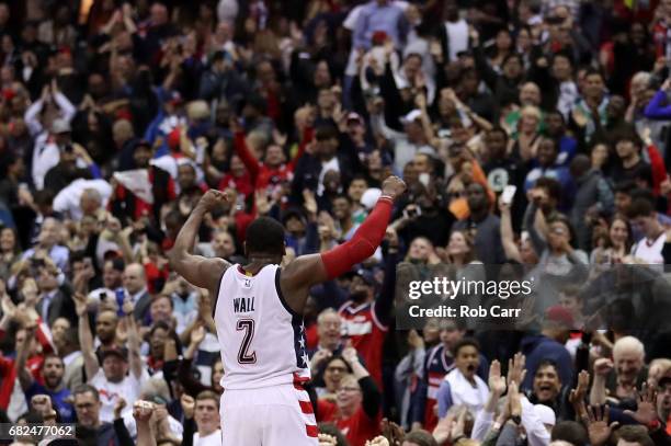 John Wall of the Washington Wizards reacts after hitting the game-winning three-point basket in their 92-91 win over the Boston Celtics during Game...