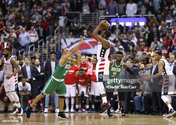 John Wall of the Washington Wizards shoots the game-winning three-point basket against Avery Bradley of the Boston Celtics during Game Six of the NBA...