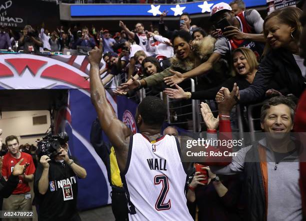 John Wall of the Washington Wizards reacts after hitting the game-winning three-point basket in their 92-91 win over the Boston Celtics during Game...