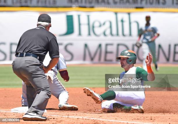 Miami infielder Johnny Ruiz slides into third during a college baseball game between the Bethune-Cookman University Wildcats and the University of...