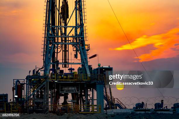 drilling rig at sunset in basra - iraq oil stock pictures, royalty-free photos & images
