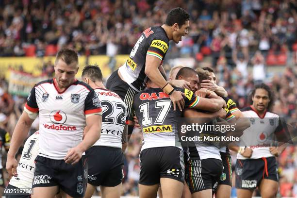 Matt Moylan of the Panthers celebrates with his team mates after scoring a try during the round 10 NRL match between the Penrith Panthers and the New...