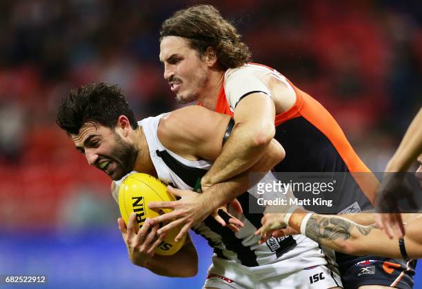Alex Fasolo of the Magpies is tackled by Phil Davis of the Giants during the round eight AFL match between the Greater Western Sydney Giants and the...
