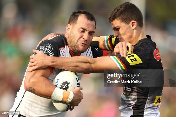 Bodene Thompson of the Warriors tries to evade the tackle of Nathan Cleary of the Panthers during the round 10 NRL match between the Penrith Panthers...