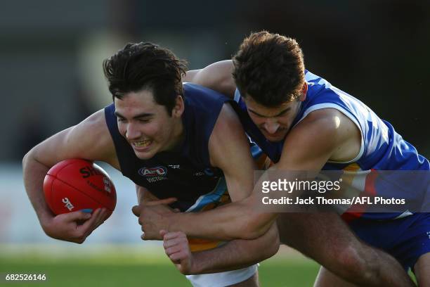 Tom Campbell of the Pioneers is tackled by Harrison Nolan of the Ranges during the round seven TAC Cup match between the Eastern Ranges and the...
