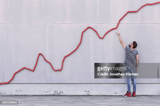red line graph with man - crescita foto e immagini stock