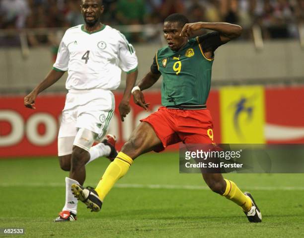 Samuel Eto'o of Cameroon scores the opening goal of the match during the FIFA World Cup Finals 2002 Group E match between Cameroon and Saudi Arabia...