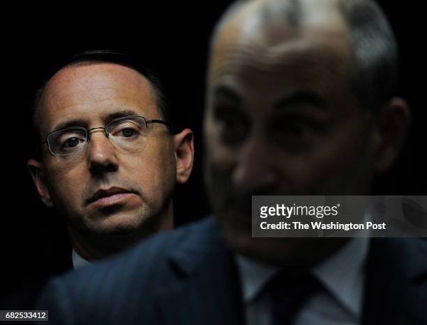 Rod J. Rosenstein, United States Attorney listens as Gregg L. Bernstein, Baltimore City State's Attorney answers a question during a press conference...