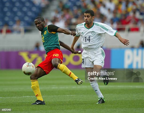 Lauren of Cameroon reaches the ball ahead of Abdulaziz al Khathran of Saudi Arabia during the FIFA World Cup Finals 2002 Group E match played at the...