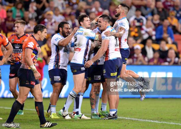 Chris McQueen of the Titans is congratulated by team mates after scoring a try during the round 10 NRL match between the Melbourne Storm and the Gold...