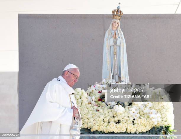Pope Francis celebrates a centenary mass marking the apparition of the Virgin Mary at Fatima's Sanctuary, central Portugal, on May 13, 2017. - Two of...