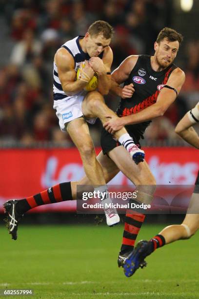 Joel Selwood of the Cats marks the ball against Matthew Leuenberger of the Bombers during the round eight AFL match between the Essendon Bombers and...