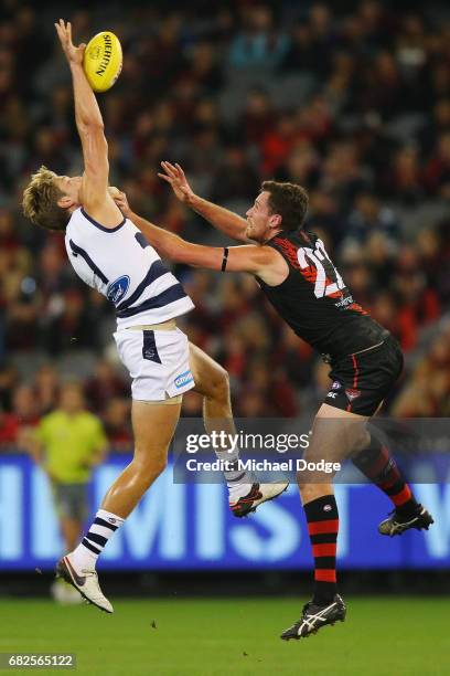 Zac Smith of the Cats and Matthew Leuenberger of the Bombers compete for the ball at the first bounce during the round eight AFL match between the...