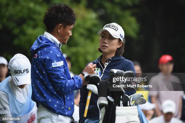 Erina Hara of Japan speaks with her caddie before her tee shot on the 10th hole during the first round of the Hoken-no-Madoguchi Ladies at the...