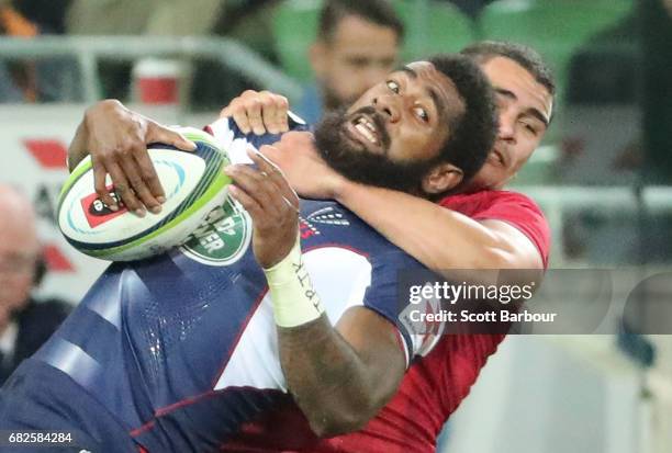Marika Koroibete of the Rebels is tackled during the round 12 Super Rugby match between the Melbourne Rebels and the Queensland Reds at AAMI Park on...