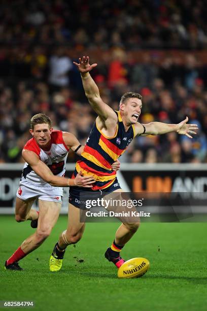 Josh Jenkins of the Crows appeals for a free kick as he is tackled by Sam Frost of the Demons during the round eight AFL match between the Adelaide...