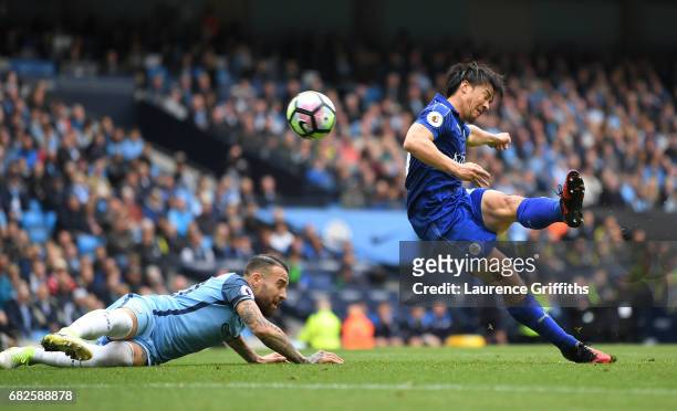 Shinji Okazaki of Leicester City scores his sides first goal during the Premier League match between Manchester City and Leicester City at Etihad...