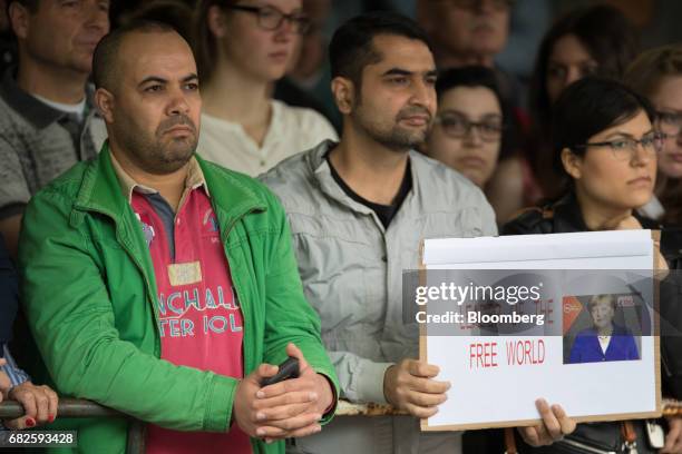 Supporters hold a sign depicting Angela Merkel, Germany's chancellor and Christian Democratic Union leader, and reading 'Leader Of The Free World'...