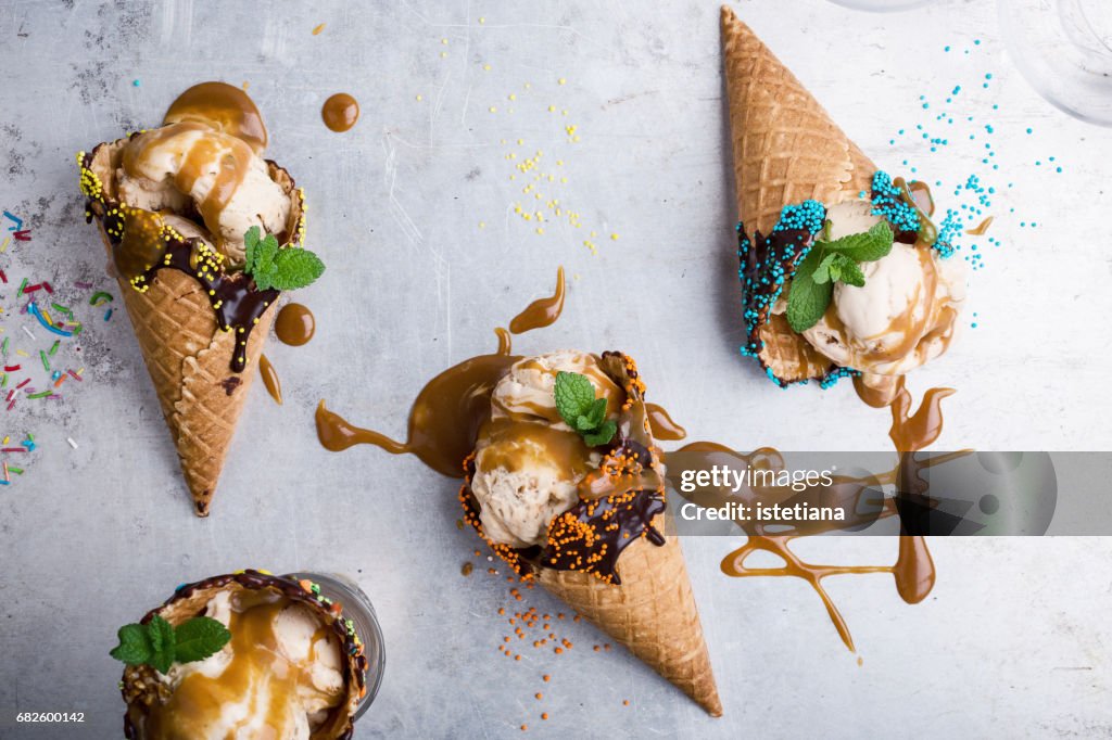 Ice cream with caramel sauce in waffle cone