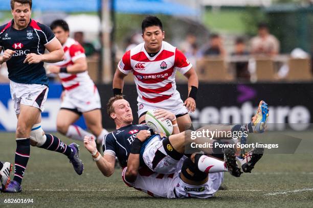 Yoshitaka Tokunaga of Japan puts a tackle on Alex McQueen of Hong Kong during the Asia Rugby Championship 2017 match between Hong Kong and Japan on...