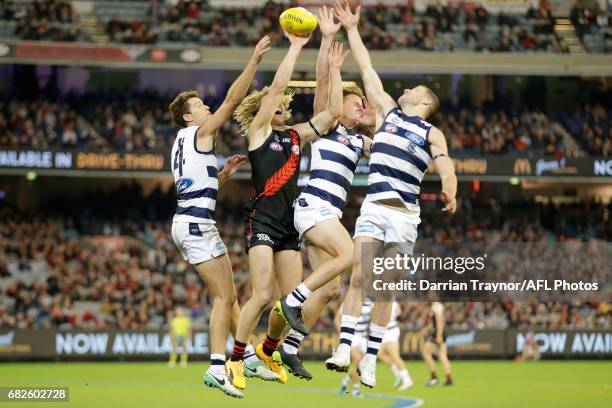 Andrew Mackie, Mitch Duncan and Sam Menegola of the Cats compete against Dyson Heppell of the Bombers during the round eight AFL match between the...