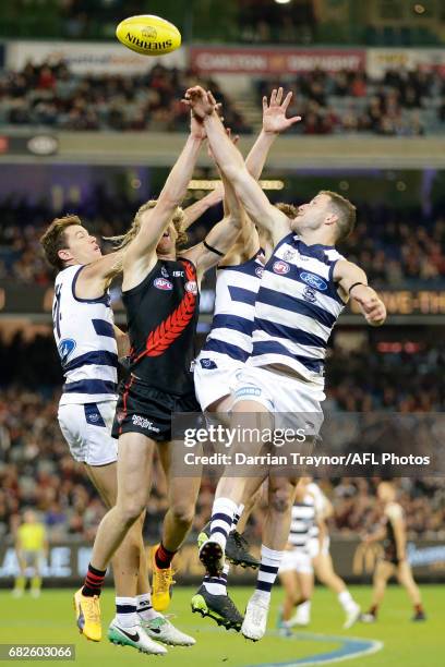 Andrew Mackie, Mitch Duncan and Sam Menegola of the Cats compete against Dyson Heppell of the Bombers during the round eight AFL match between the...